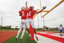 Sam Markham celebrates a TD catch with P.J. Carey. He earned D3football.com all-America honors after leading Division III with a school-record 104 catches for 1,215 yards.