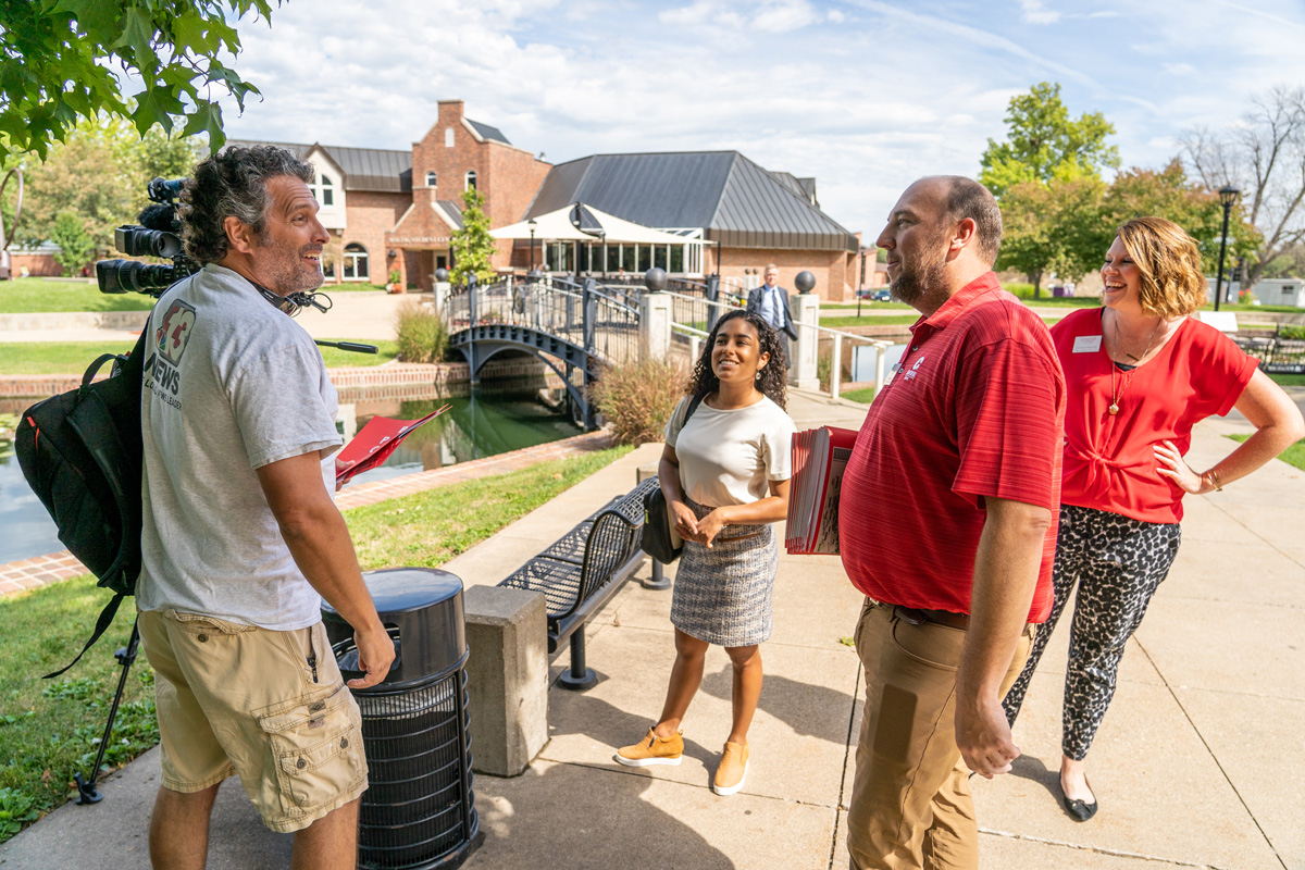 Television personnel chat with Central communications staff Jeff Bersch and Steffanie Bonnstetter (in red shirts) following the announcement of Central’s new tuition price. The announcement garnered national media attention including CNN, Forbes, The New York Times and more.