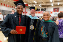 President Mark Putnam, center, and Associate Professor of Music Gabriel Espinosa ’79 congratulate Jeremy Vester ’19 following graduation.