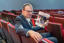 Kyle Munson ’94 sits in Douwstra Auditorium holding the Spring 1994 issue of Central Bulletin, then the alumni magazine. As a senior, Munson wrote an editorial titled “Now What?”