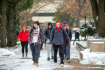 Students walking on Peace Mall during snowy weather.