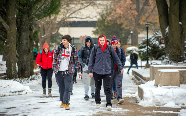 Students walking on Peace Mall during snowy weather.