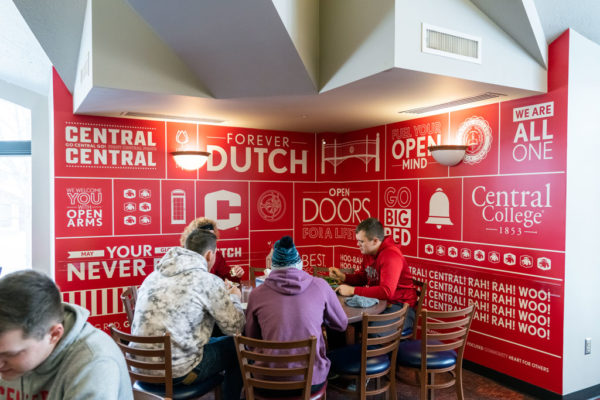 Students eating in Central Market, alongside recently installed artwork.