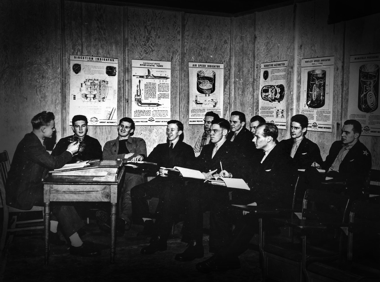 Navy cadets in a classroom with Marvin Baker, instructor.