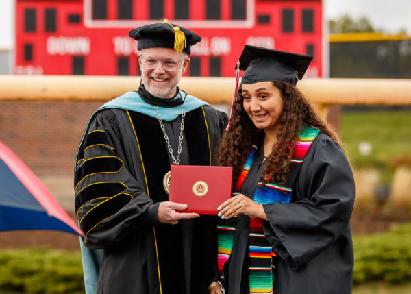 President Mark Putnam and a 2020 Central graduate.