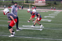 Football practice at Central in a pandemic meant face masks and small-group workouts, like Assistant Coach Austin Mercer put his cornerbacks through.