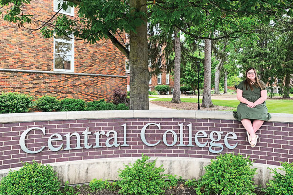 Bella Van Gorp posing near a Central College sign.