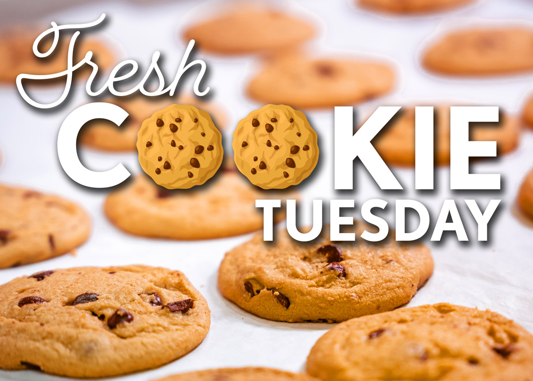 Text that reads, "Fresh Cookie Tuesday," over a background photo of fresh chocolate chip cookies.