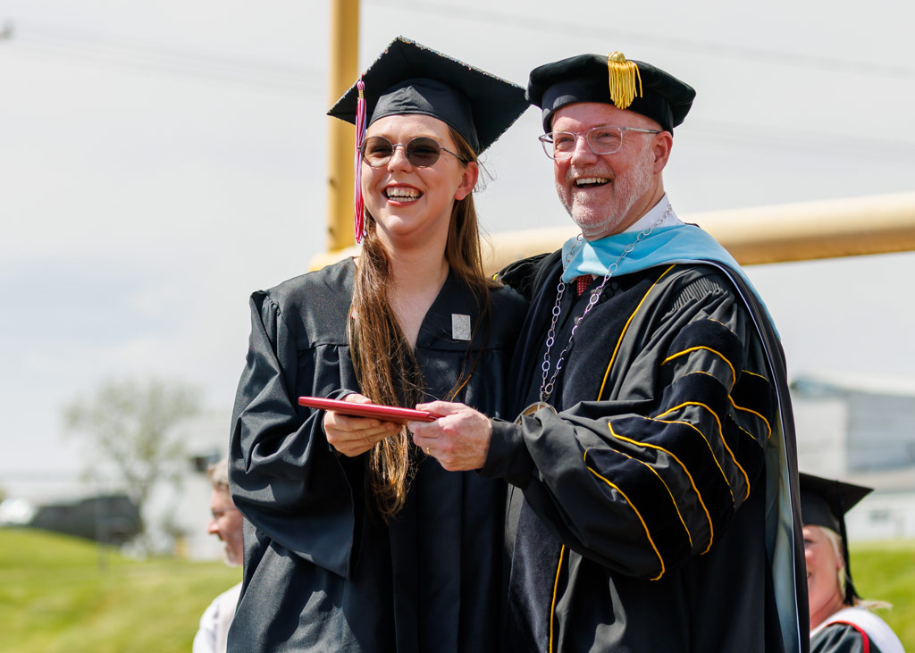 Central College President Mark Putnam, with 2022 graduate Abigail Lowry.