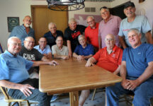 Several of Max “Dubit” Vander Pol’s friends and some former Central student employees at Dubit’s Steak House in the 1960s-70s dropped in to his Pella home in June. Seated, left to right: John Carle ’60, John Danks ’69, Steve Paris ’73, Tom Hall ’61, Herb Blom ’61, Max Vander Pol and Cliff Marlow ’75. Standing: John Goode ’79, Steve Bancroft ’70, Alex Glann ’69, Del Miller ’72, Al Dorenkamp ’75 and Al Paris ’77.