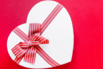 Graphic of a heart with a red bow